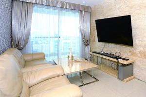 a living room with a couch and a flat screen tv at Lux SL Luxury Style of Life 5 in North Pattaya