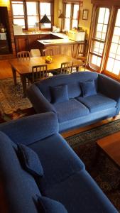 a living room with a blue couch and a table at Redgum Hill Country Retreat in Balingup