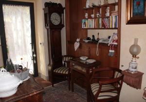 a room with a desk and a grandfather clock at Ulivo Rosso in Sesto Fiorentino