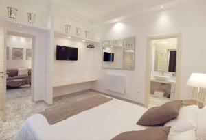 - un salon blanc avec un canapé et un lavabo dans l'établissement FLOS Guest House, à Lucera