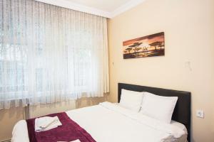 Postel nebo postele na pokoji v ubytování Berce Apartments