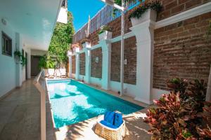 a swimming pool in the middle of a house at El Cactus Luxury Apartments in Historic Center in Santa Marta +50 photos