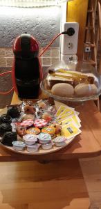 a table with a tray of donuts and a toaster at LOGE DE L'OPERA in Lyon