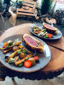 two plates of food on a wooden table at Stary Zajazd in Zielona Góra +17 photos