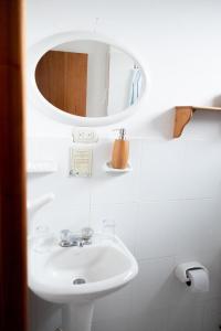 a bathroom with a sink and a mirror at Hostal Santa Maria in Floreana