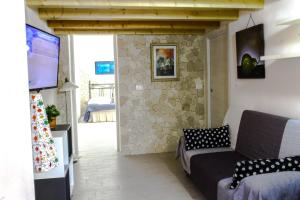 a living room with a couch and a tv at Fausto's House 2 in Syracuse