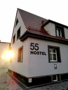 a white building with the words hospital on it at Hostel 55 - darmowy parking in Wrocław