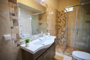 a bathroom with a sink and a shower at Chioni's Houses in Chios +23 photos