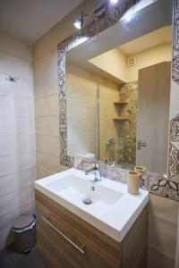 a bathroom with a sink and a mirror at Chioni's Houses in Chios