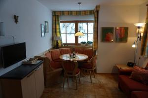 a living room with a table and a couch at Haus Johannes in Wagrain