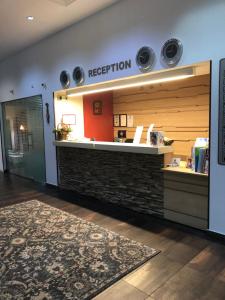 a reception area of a restaurant with a mirror at Olymp Hotel in Bansko