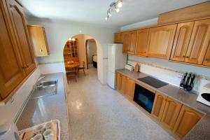 a kitchen with wooden cabinets and a counter top at Villa Isabel in Murcia