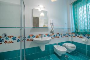 a bathroom with a sink and a toilet and a shower at La Casetta in Agerola +35 photos