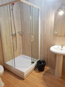 a shower stall in a bathroom with a sink at Casa Someseana in Gîlgău +82 photos