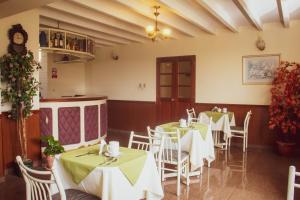 a restaurant with tables and chairs with green tablecloths at Hotel Internacional in Lima