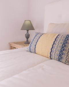 a bed with a pillow and a lamp on a table at Invicta Flats 2 - Oporto in Porto