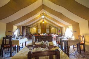 a large dining room with tables and chairs at Sahara Majestic Luxury Camp in Merzouga