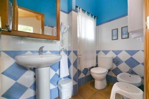 a blue and white bathroom with a sink and a toilet at Casa Rural La Cambreta in Crevillente +17 photos