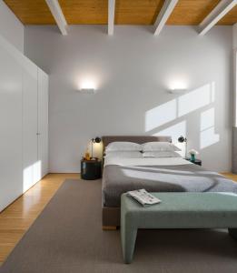 a bedroom with a large bed and a green ottoman at Flattered to be in Porto in Porto +37 photos