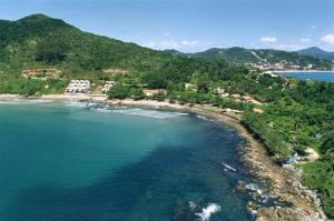 an aerial view of an island in the ocean at Pousada Residencial dos Corais in Bombinhas