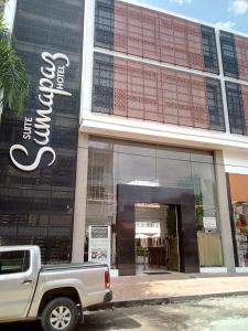 a white truck parked in front of a building at Suite Sumapaz Hotel in Melgar