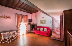 Bargello Florence في فلورنسا: غرفة معيشة مع أريكة حمراء وطاولة