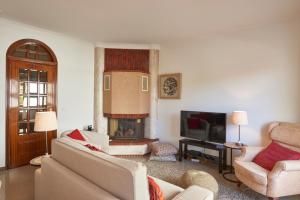 a living room with a couch and a fireplace at Cascais Handsome Apartment in Cascais