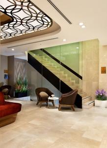 a lobby with a red couch and chairs and stairs at Sorriso Hotel in Istanbul