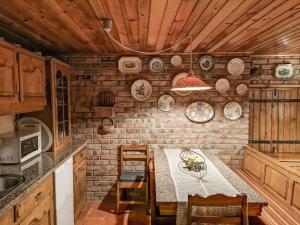 a kitchen with a table and some plates on the wall at Casa do Penedo Gerês in Terras de Bouro