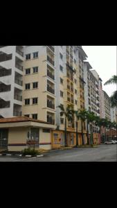 a city street with tall buildings and palm trees at Suria Apartment 1BEDROOM Bukit Merah in Simpang Ampat Semanggol