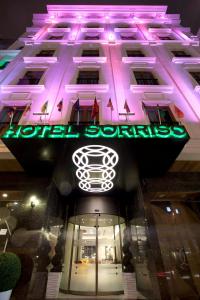 a building with a neon sign in front of it at Sorriso Hotel in Istanbul