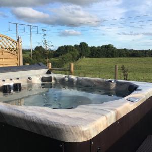 a large hot tub in a retaining wall at Arvalee Retreat With Outdoor HotTub in Omagh