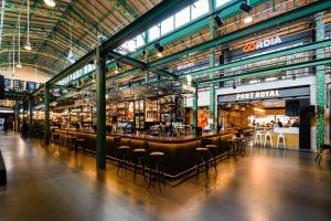 a large building with a bar with stools in it at P&O Apartments Metro Centrum in Warsaw