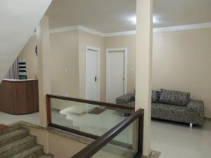 a living room with a glass table and a couch at Pousada Águia in Vera Cruz de Itaparica