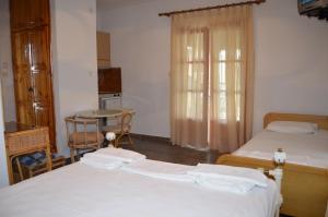 Postel nebo postele na pokoji v ubytování Hotel Rigakis