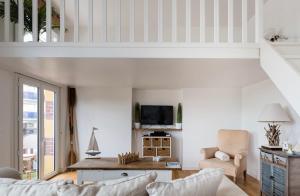 a living room with a couch and a table at Appartement Bien-être 2 chambres au coeur de Cabourg - in Cabourg