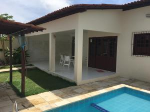 a villa with a swimming pool and a house at Casa Praia de Tamandaré PE in Tamandaré