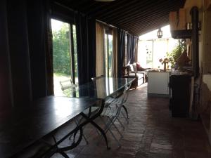 a dining room with a glass table and chairs at PoggioBa in Sovana