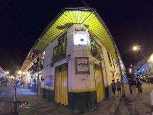 a building with an archway on a street at night at The Corner House Hostel in Salento