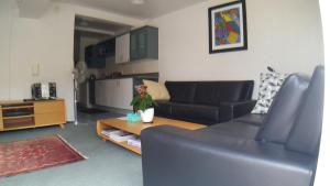ein Wohnzimmer mit einem Sofa und einem Tisch in der Unterkunft Austria Motel in Paihia