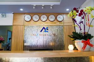 a display of clocks on a wall with a new amsterdam sign at Nam Anh Hotel in Buon Ma Thuot