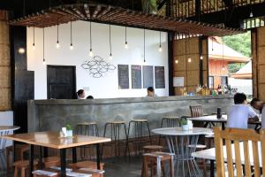 a group of people sitting at tables in a restaurant at Saltitude Dive & Beach Resort in Mabini