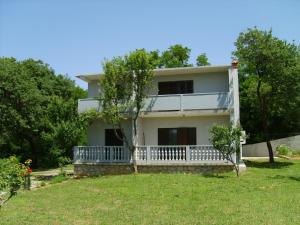 a white house with a porch and trees at Apartment in Lopar/Insel Rab 17747 in Lopar