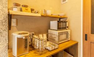 a kitchen with a microwave and a toaster oven at cup of tea in Takayama