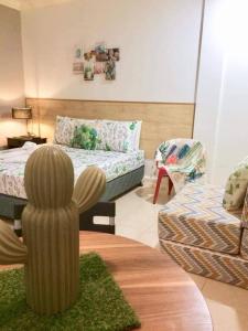 a living room with a couch and a cactus at VL Garden Suites in Tagbilaran City