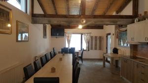 a dining room with a long table and chairs at Casa Bella in Vadu Moţilor