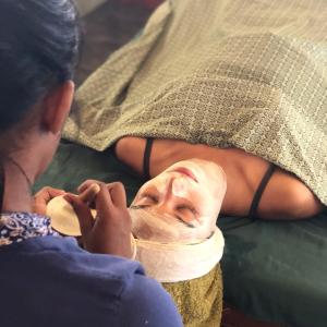 a woman laying on a bed with a head reconstruction at Mana Eco Retreat in Kuta Lombok