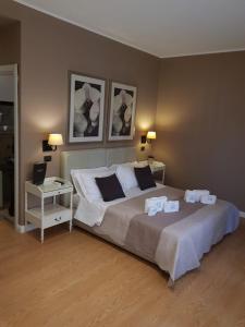 a bedroom with a large bed with two night stands at Maxim in Palermo