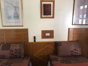 a bedroom with two beds and two pictures on the wall at Phi Phi Dream Guest House in Phi Phi Islands