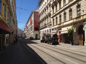 an empty street in a city with buildings at Walzhofer Apartement in Vienna